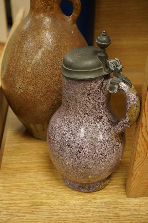 A lead glazed and manganese pewter-mounted ewer, a salt glazed pitcher and a terracotta pot, tallest 35cm